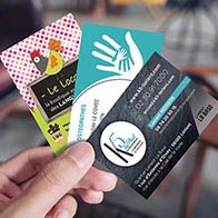 Closeup image of a man's hand holding empty business card in caf